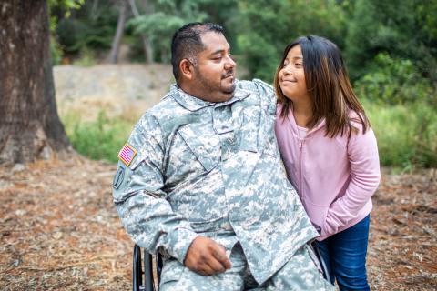 Hispanic veteran spends time with his eight-year old daughter outdoors