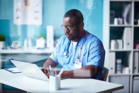 A physician uses health IT in his office to improve the delivery of services
