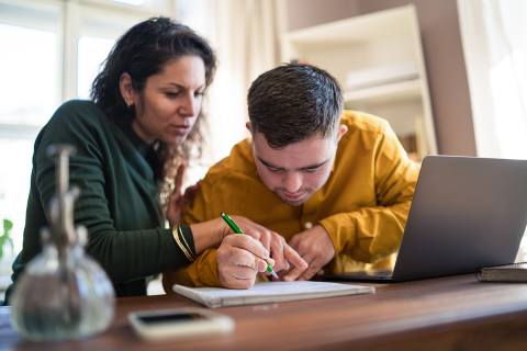 A woman helping a person with special needs.